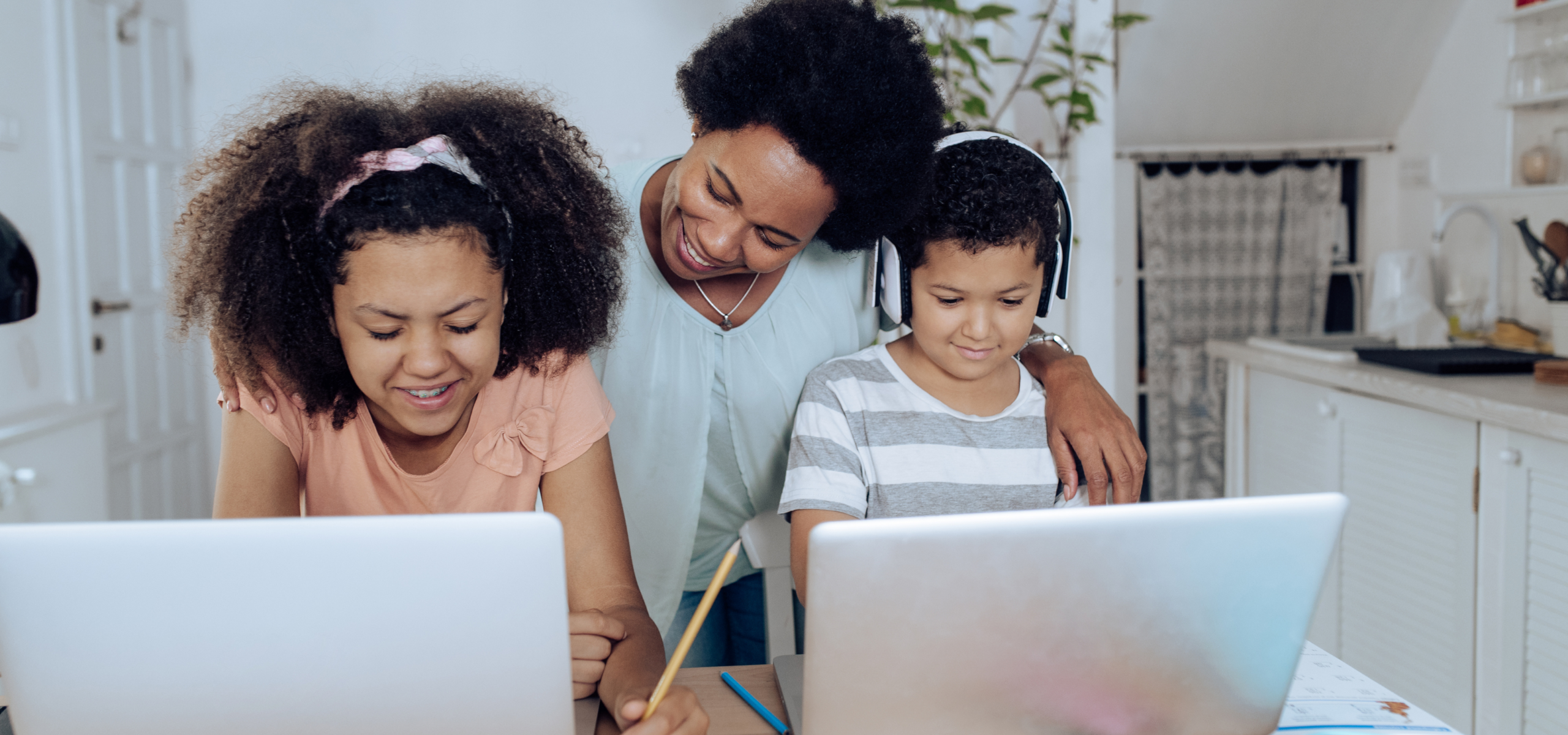Parent supporting children using Castle Learning for Home for K–12 homeschool practice