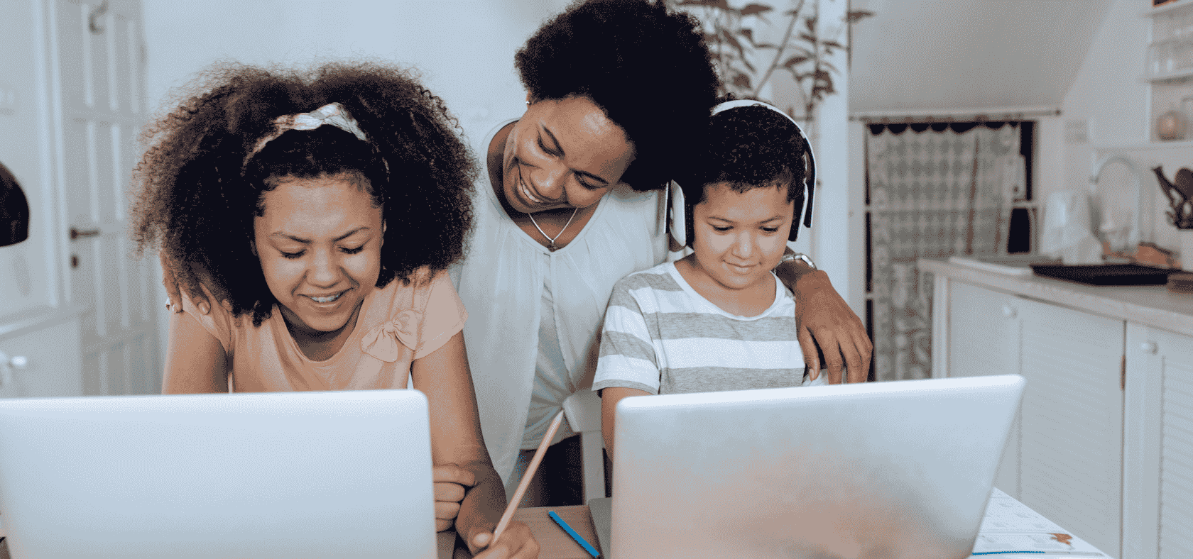 Parent supporting children using Castle Learning for Home for K–12 homeschool practice