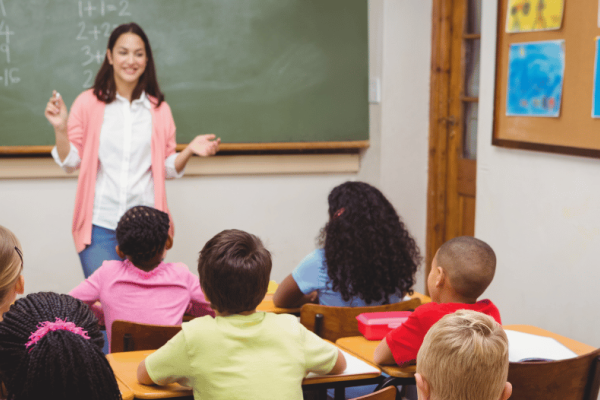 Teacher in front of her class teaching
